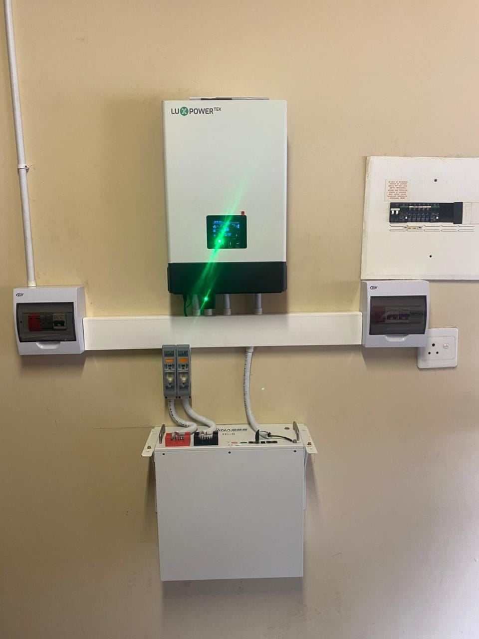 Wall-mounted hybrid inverter with battery and distribution board