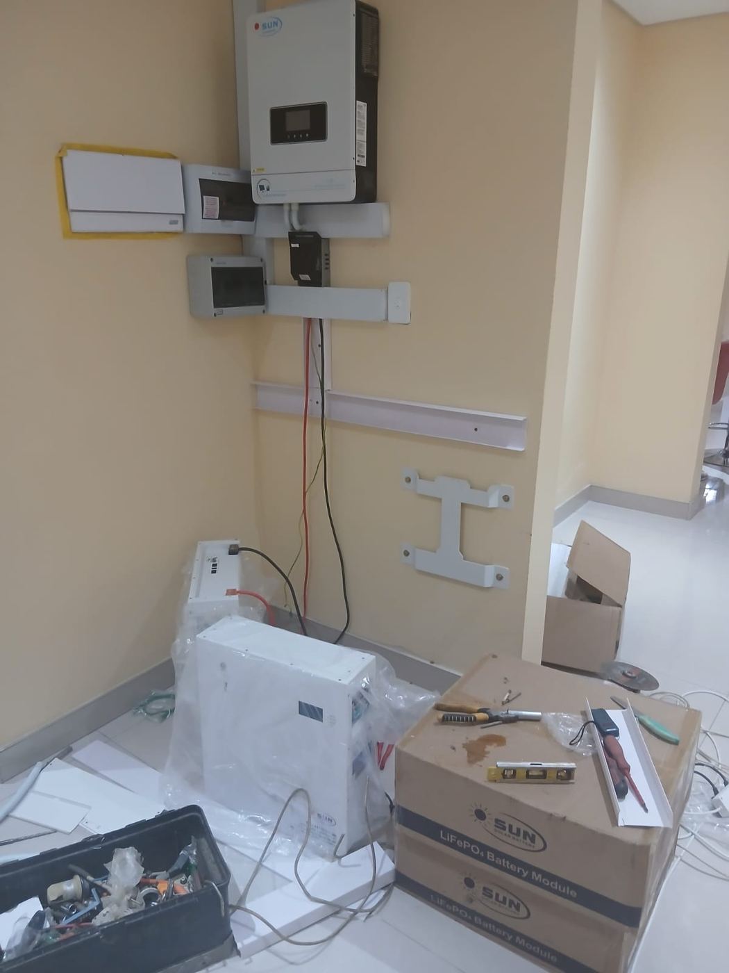 Inverter and batteries being unboxed and fitted