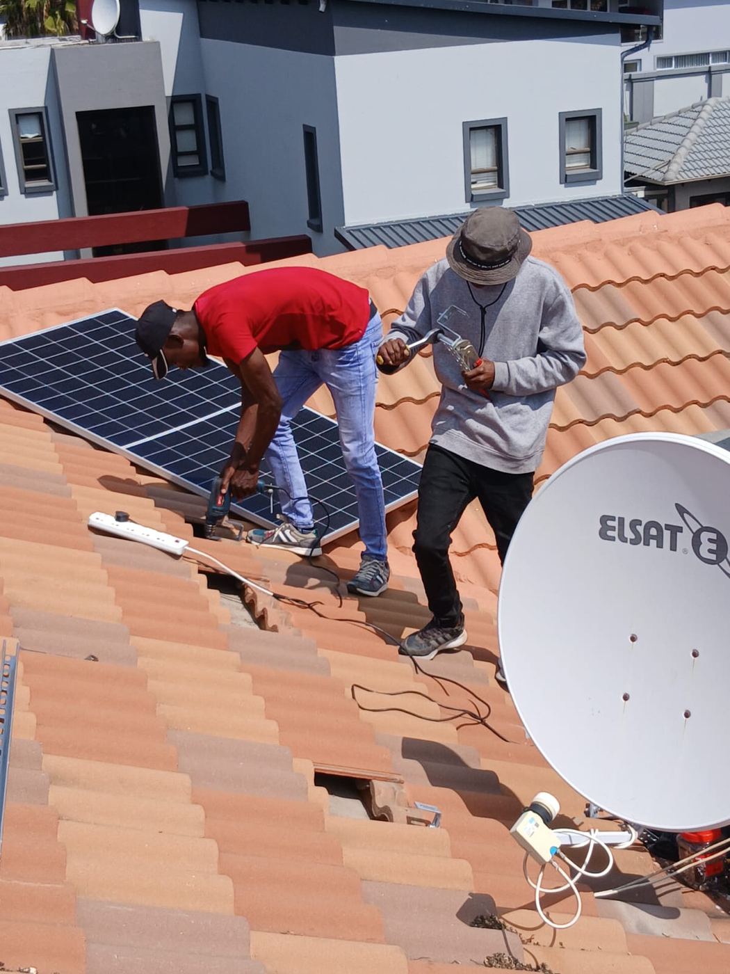 Pro Networks installers fitting solar panels on a tiled roof